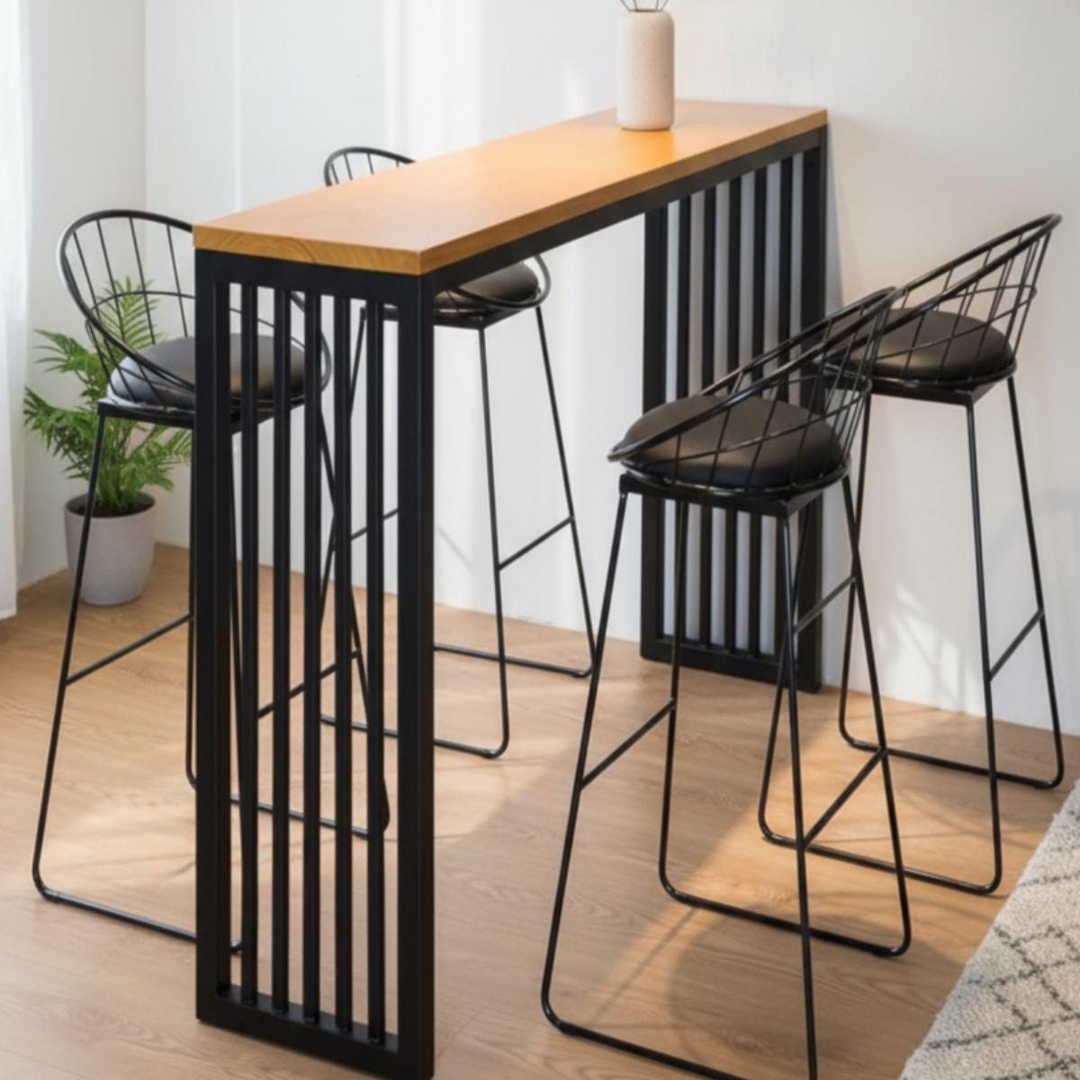 Modern bar table with wood top and metal frame used as kitchen island setup