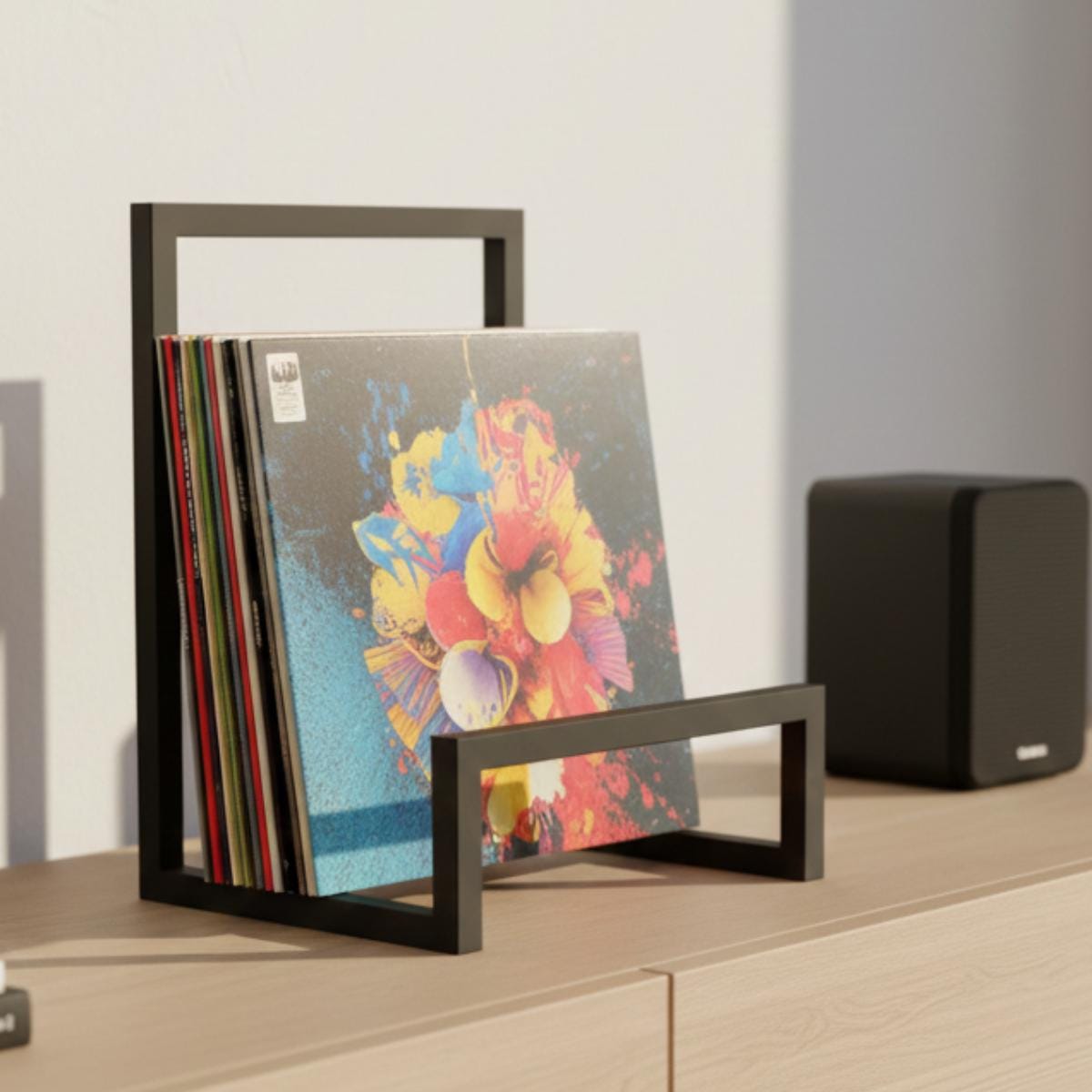 Modern vinyl record stand designed for front display of LP albums on tabletop